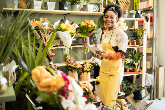 Young florist works at her flower shop