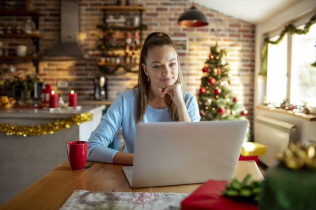 Close up of a woman using a laptop at home